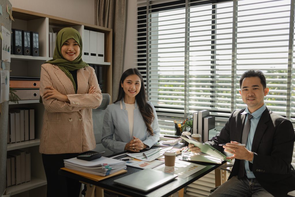 Business team in Malaysia discussing SMS Service Malaysia compliance with local regulations