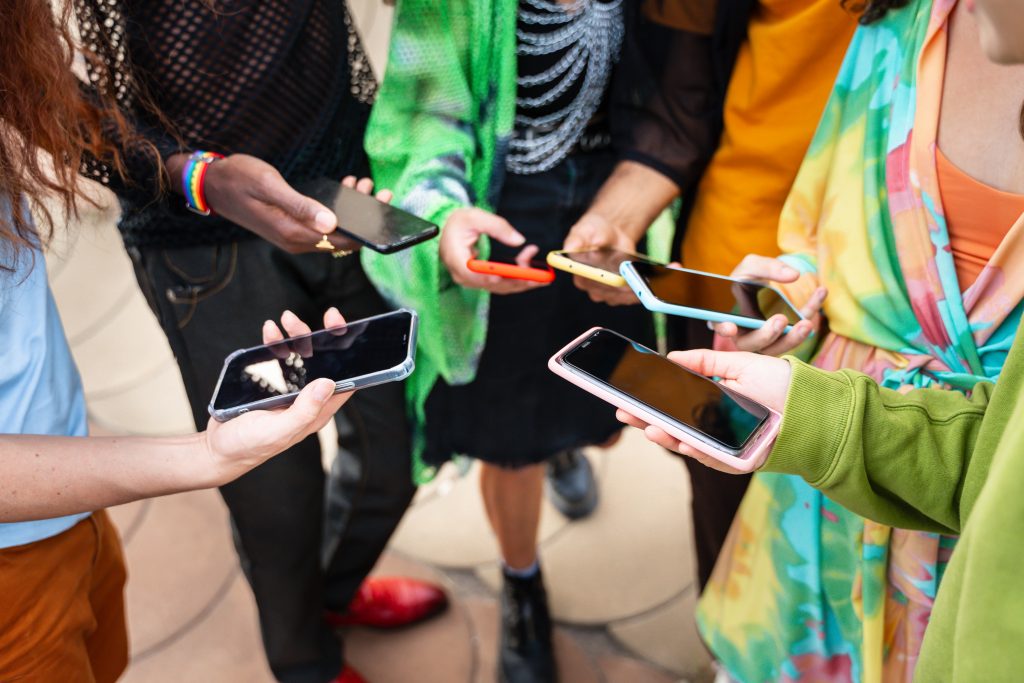 A group of people holding smartphones, symbolising bulk SMS services compared with an SMS gateway provider solution.