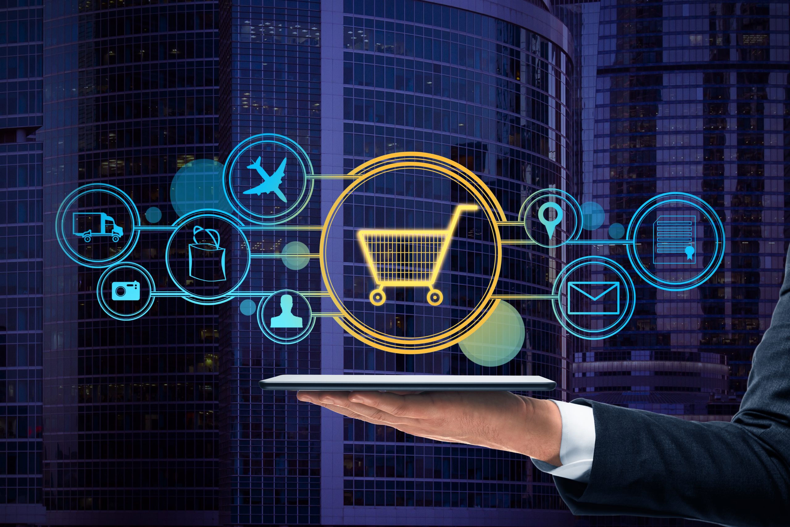 A hand holding a tablet displaying digital shopping cart icons representing e-commerce connections, symbolising Bulk SMS Malaysia marketing.