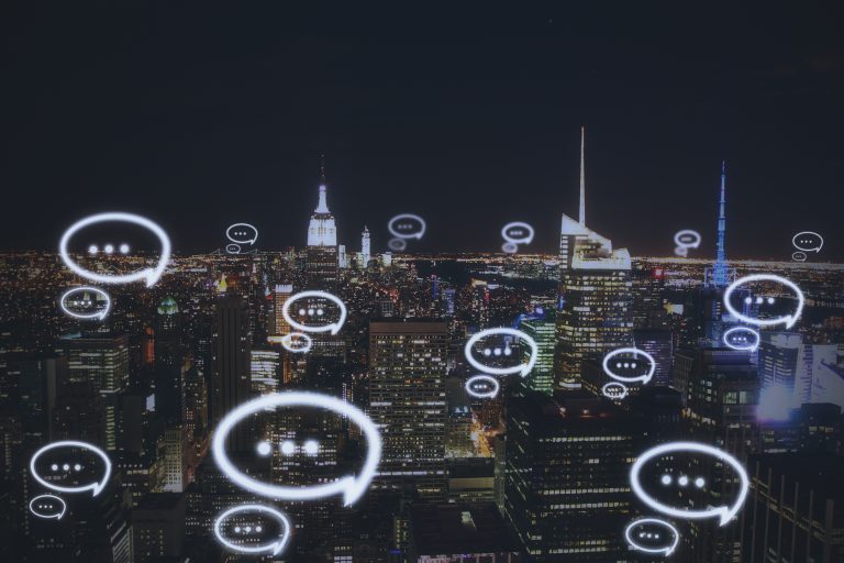 City skyline with chat message icons showing real-time global communication powered by a Messaging API