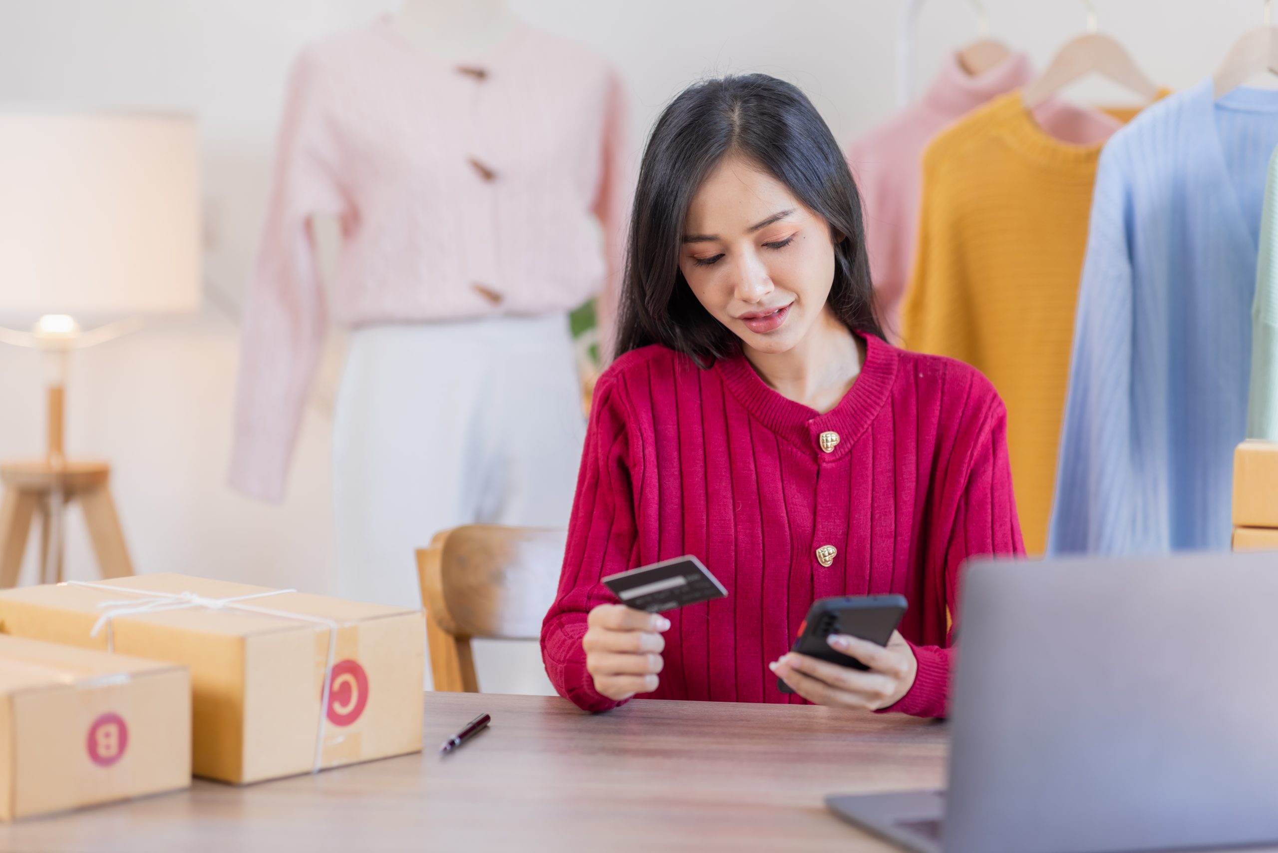 Woman managing an e-commerce order on her phone, showing how SMS Provider Malaysia supports mobile-first online sales