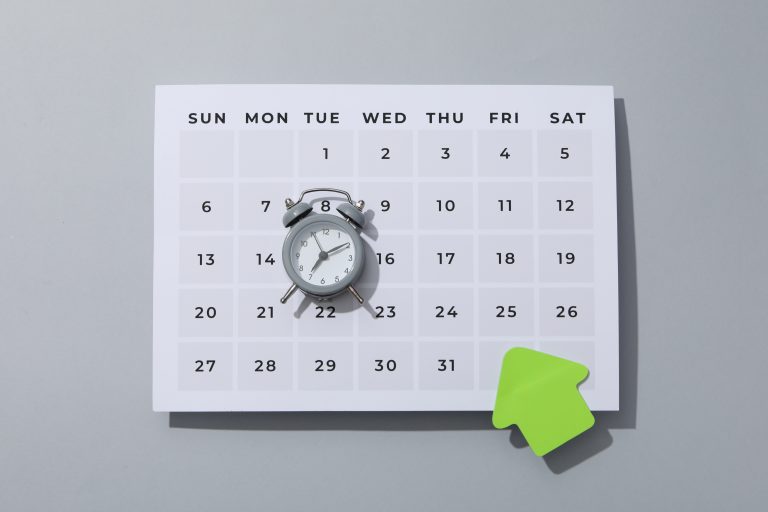 Calendar with alarm clock showing scheduled date, representing appointment reminders using SMS Service Malaysia.