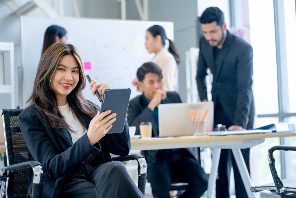 A professional team in Malaysia collaborating on selecting a reliable SMS API Malaysia provider for their business.