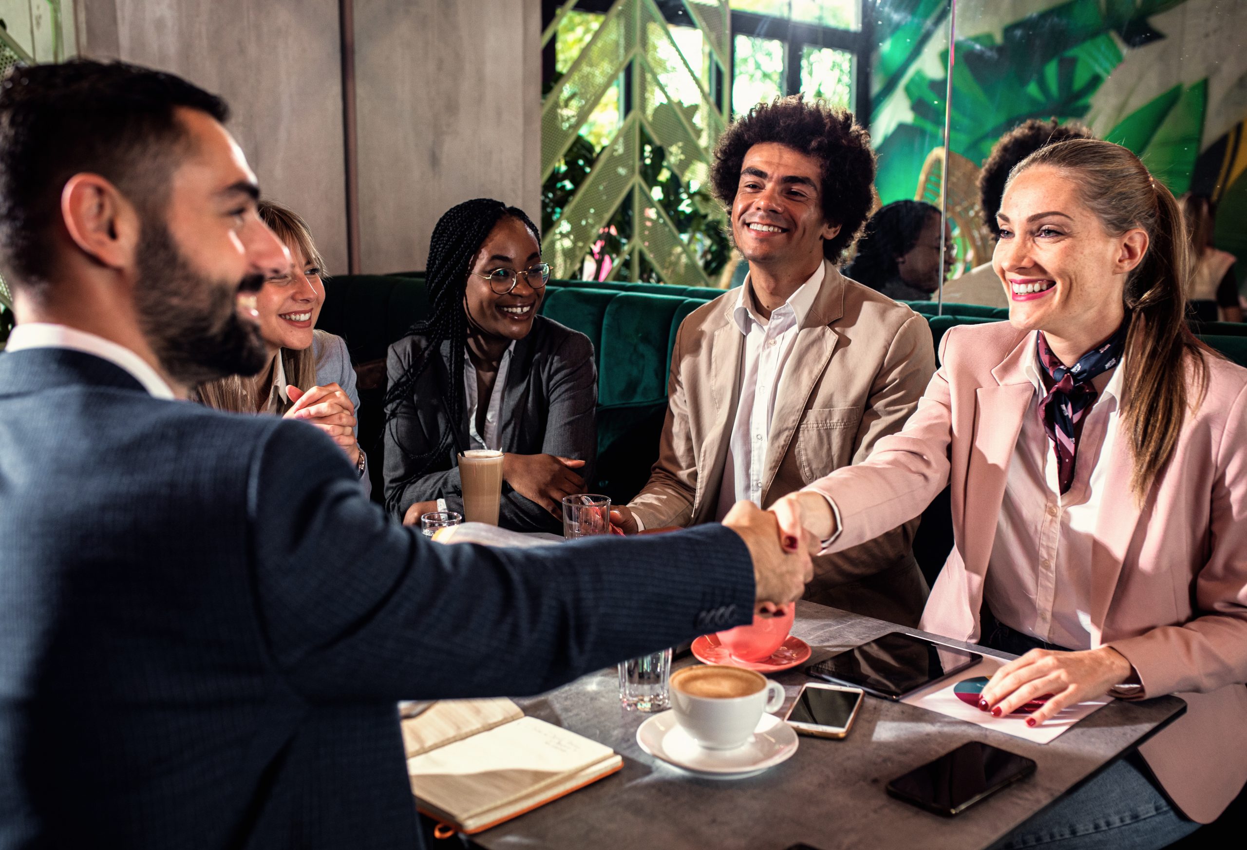 Business professionals discussing customer communication strategies using send SMS API for transactional and promotional messaging.