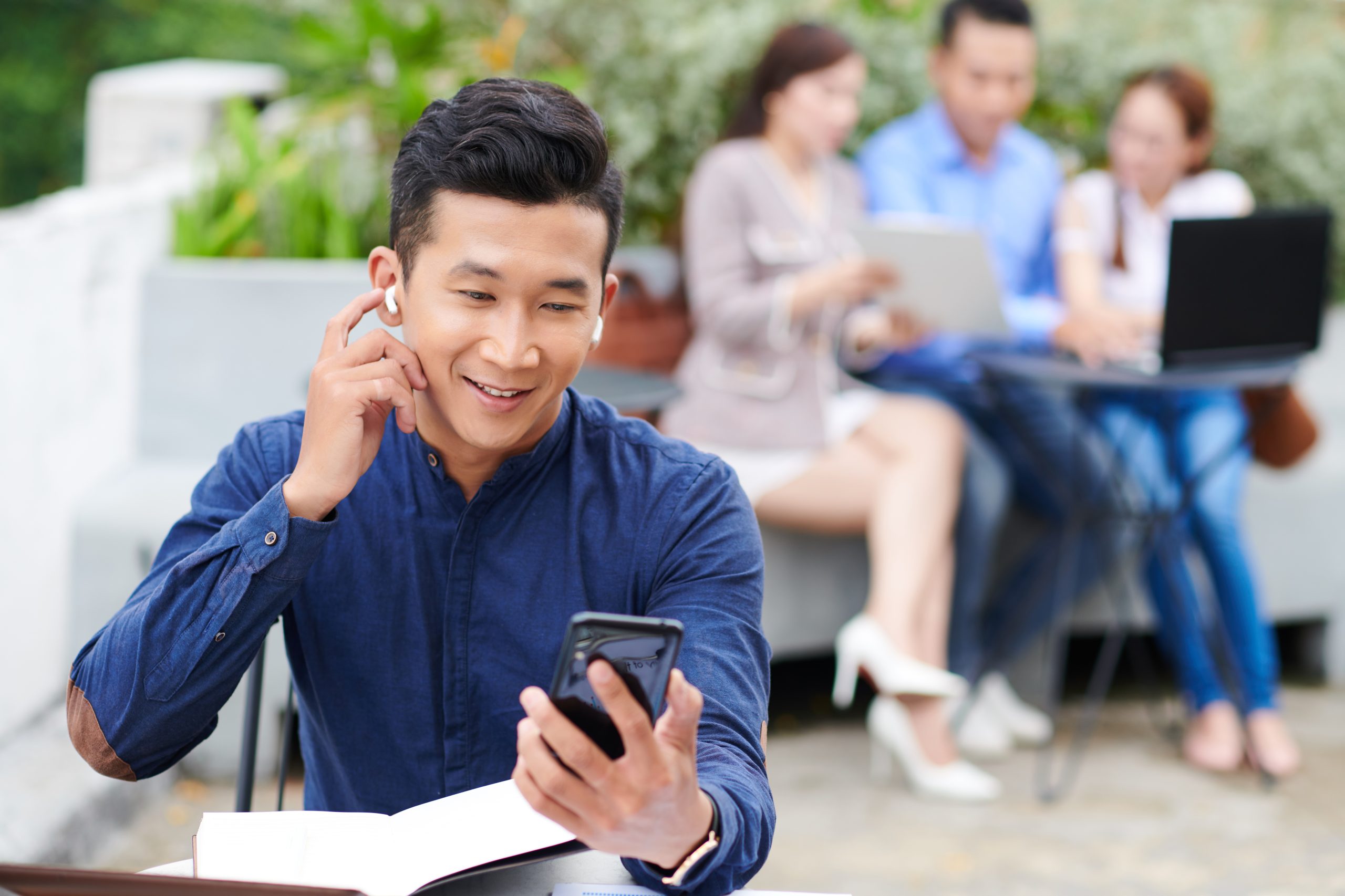 Business professional checking SMS notifications on a smartphone, illustrating modern SMS gateway provider communication trends.