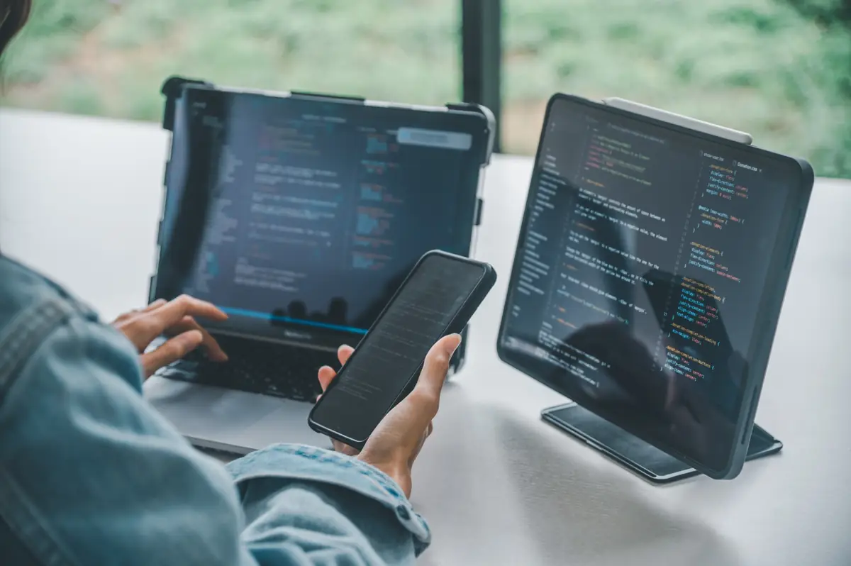 Developer integrating an SMS provider Malaysia API across web and mobile devices