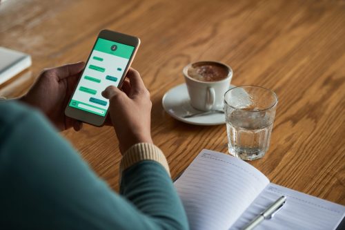 User sending a WhatsApp message on a smartphone