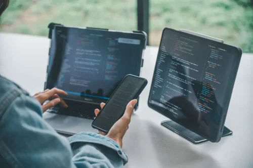 Developer integrating an SMS provider Malaysia API across web and mobile devices
